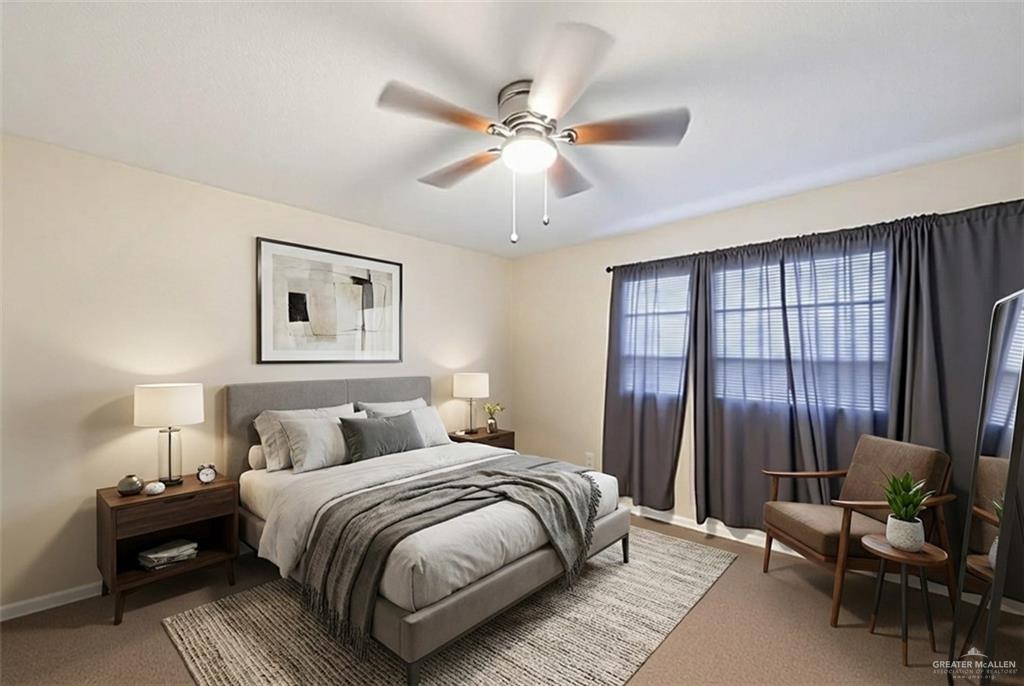 906 East Solar Drive Mission, TX 78574 - Photo 6 of 18 a bedroom with a large bed and a chandelier