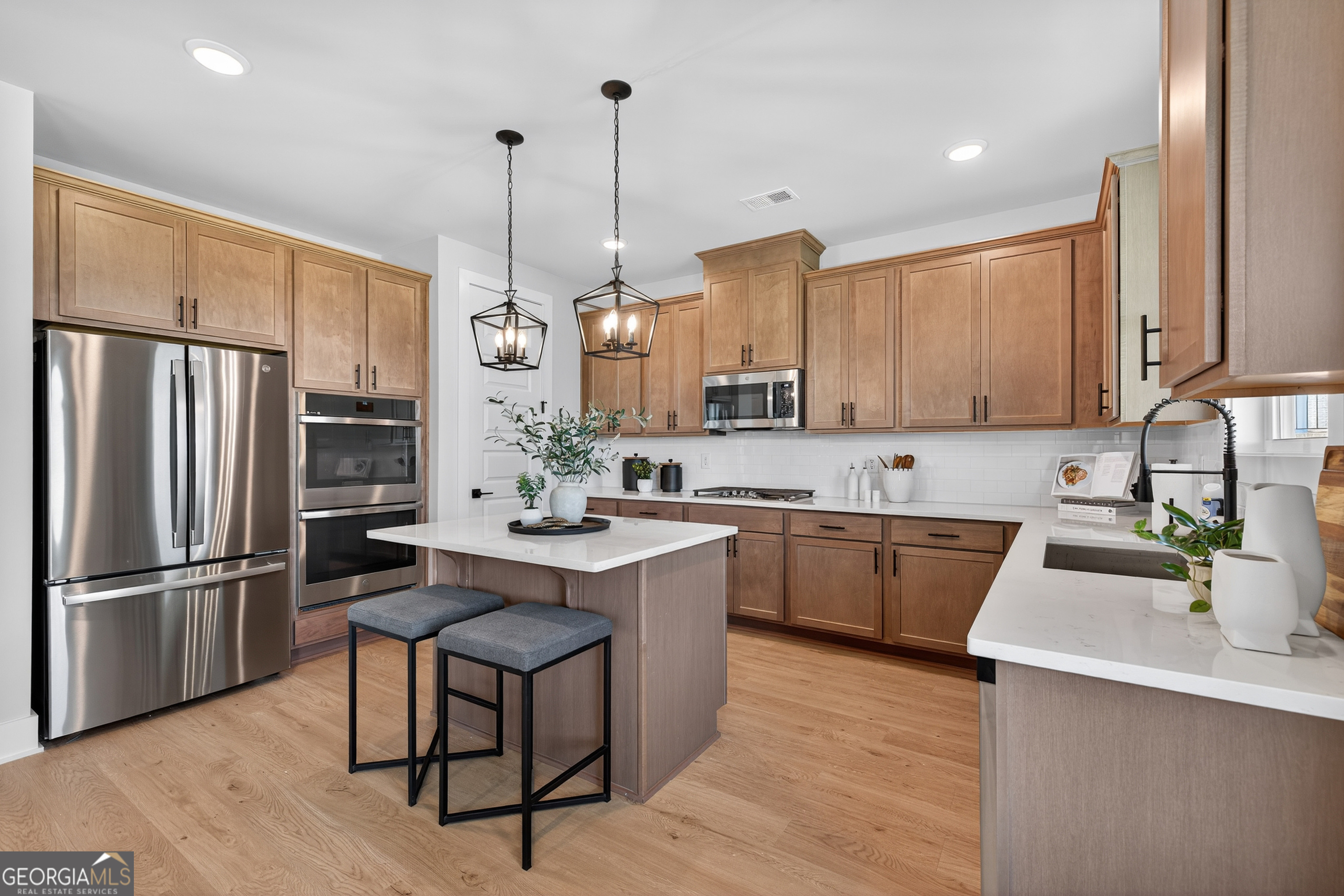 112 Patillo Manor, Unit 3 Stockbridge, GA 30281 - Photo 11 of 59 a kitchen with stainless steel appliances granite countertop a sink a stove a refrigerator and island with wooden floor