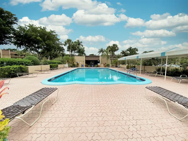 a view of a swimming pool with a yard