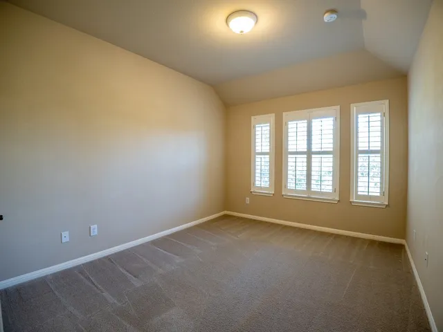 an empty room with a empty space and windows