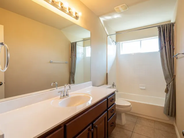 a bathroom with a tub sink toilet and a mirror