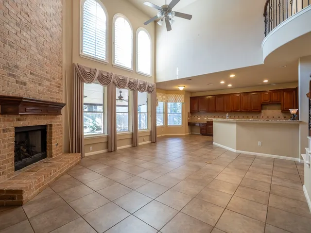 a view of a kitchen with a sink and a fireplace