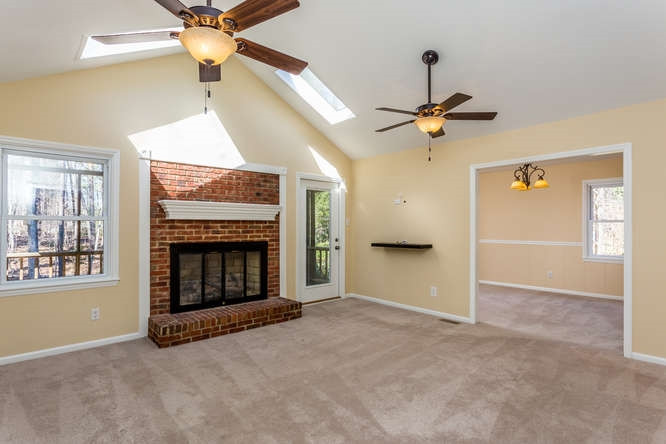 6916 Laurdane Road Raleigh, NC 27613 - Photo 5 of 23 Large living room with entrance onto back, covered deck and connected to dining room. Living Room