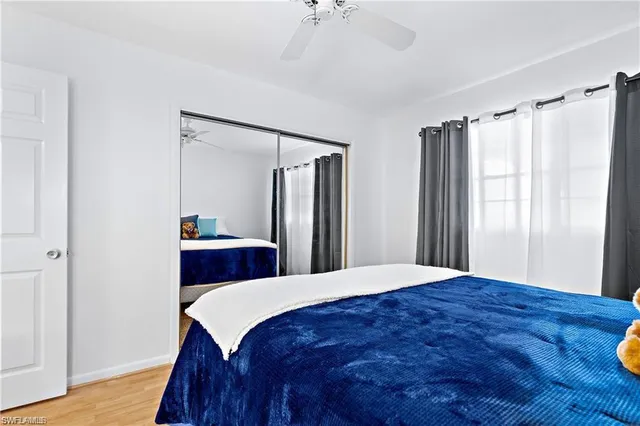 a bedroom with a bed a chandelier and a dresser