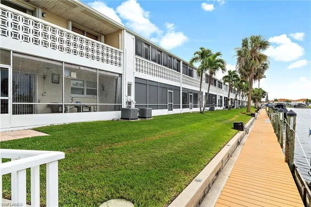 a view of a lake with a garden and trees
