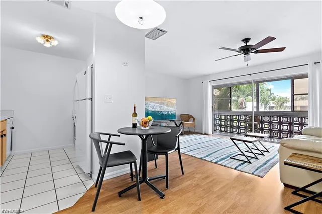 a view of a workspace with furniture and wooden floor