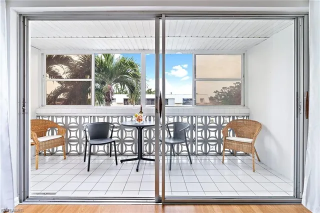 a dining room view with a glass table and glass door