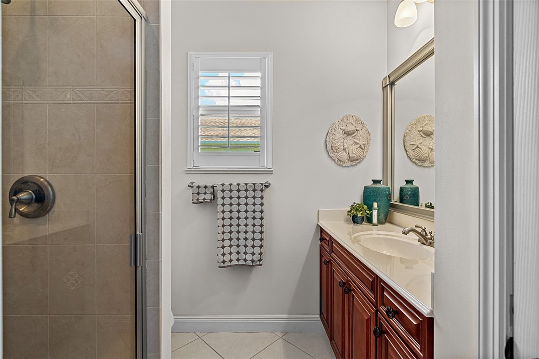 567 Gossamer Wing Way Sebastian, FL 32958 - Photo 14 of 35 a bathroom with a sink a vanity and a clock