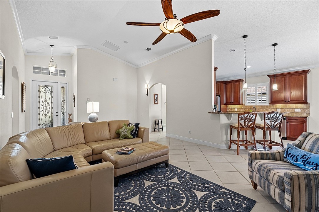 567 Gossamer Wing Way Sebastian, FL 32958 - Photo 4 of 35 a living room with furniture kitchen view and a chandelier