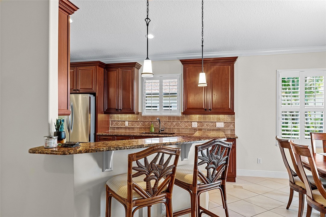 567 Gossamer Wing Way Sebastian, FL 32958 - Photo 5 of 35 a kitchen with a dining table chairs and cabinets