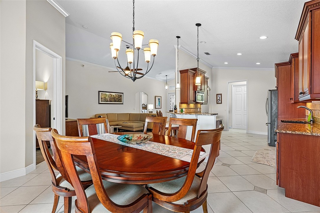 567 Gossamer Wing Way Sebastian, FL 32958 - Photo 6 of 35 a dining room with furniture a chandelier and window