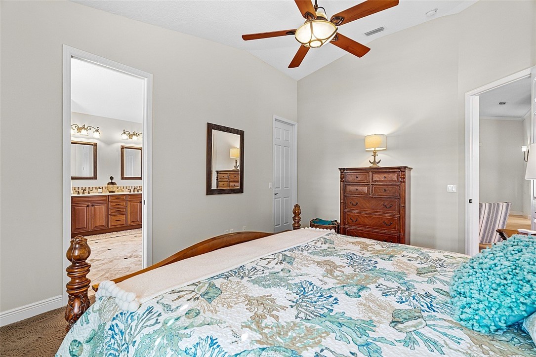 567 Gossamer Wing Way Sebastian, FL 32958 - Photo 9 of 35 a bedroom with a bed and a chandelier
