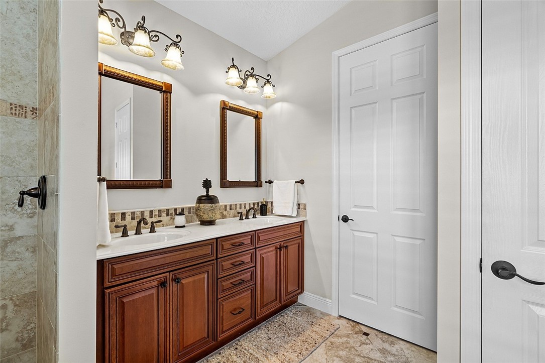 567 Gossamer Wing Way Sebastian, FL 32958 - Photo 10 of 35 a bathroom with a double vanity sink and mirror