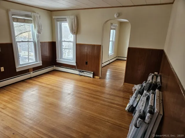 a view of a hardwood floor and staircase in a room