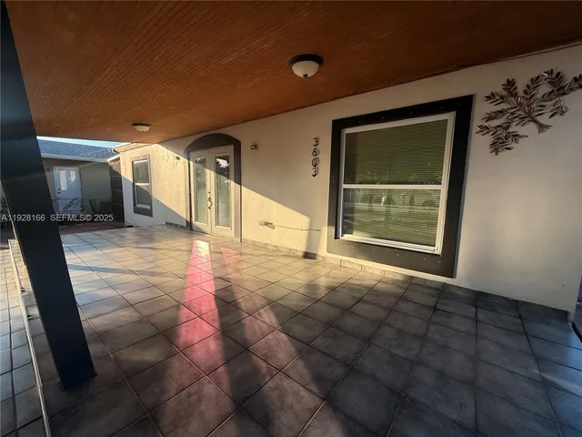 a view of a hallway with wooden floor and a fireplace