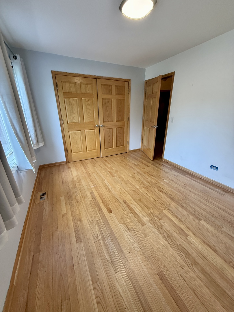 414 South Dee Road Park Ridge, IL 60068 - Photo 20 of 37 a view of an empty room with wooden floor and a window
