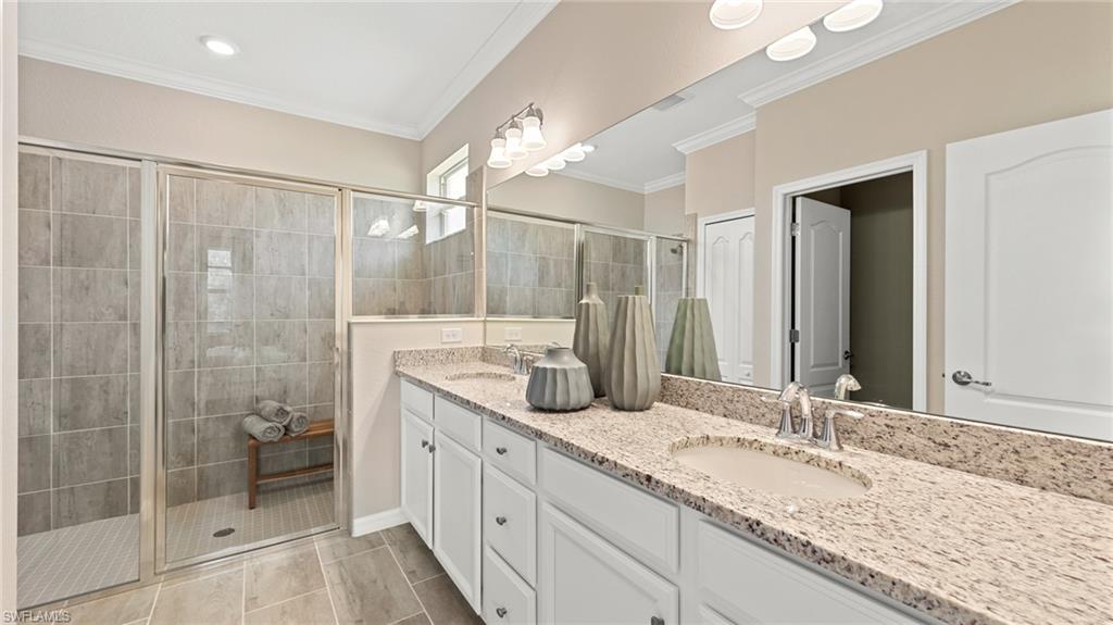 17262 Silverling Court Alva, FL 33920 - Photo 15 of 20 a bathroom with a granite countertop sink a mirror and a shower