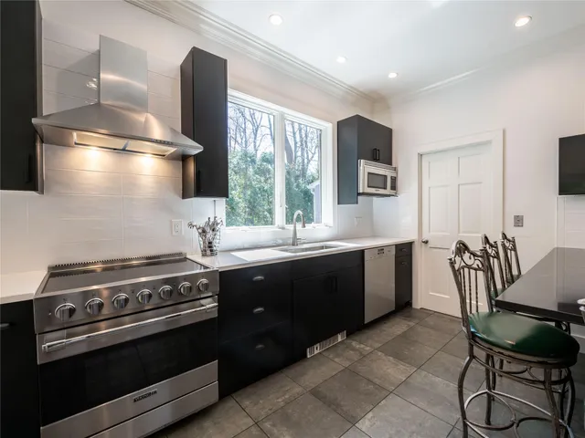 a kitchen with a stove a sink and a refrigerator