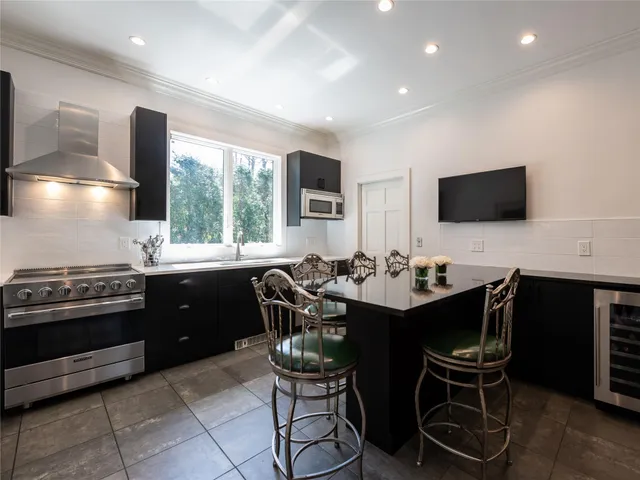 a kitchen with a dining table and chairs