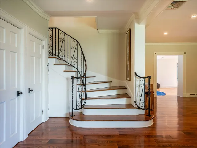 a view of entryway and hall with wooden floor