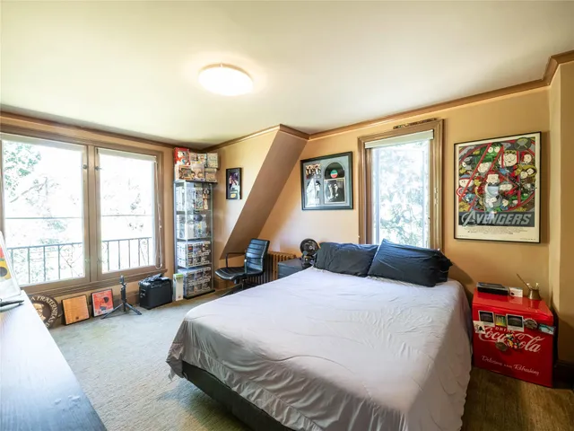 a bedroom with a large bed and a large window
