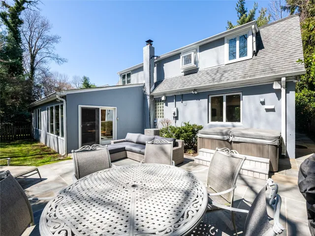 a view of a house with backyard and sitting area