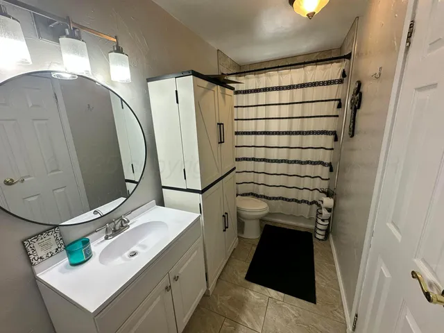 a view of a hallway with a livingroom and furniture