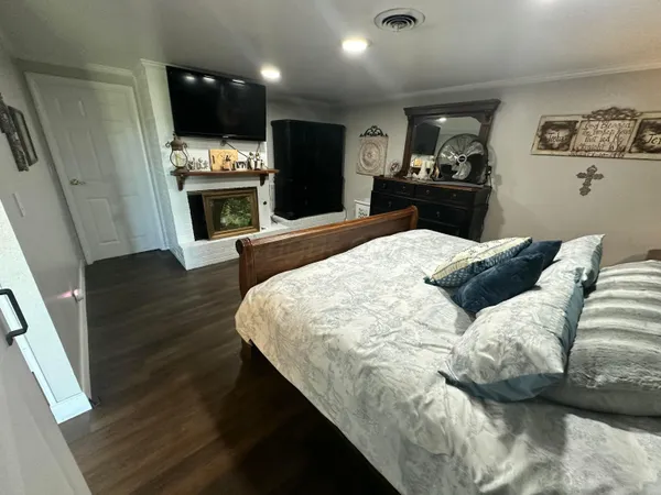 a bedroom with furniture and wooden floor