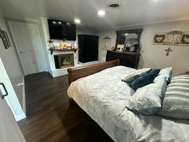 a bedroom with furniture and wooden floor