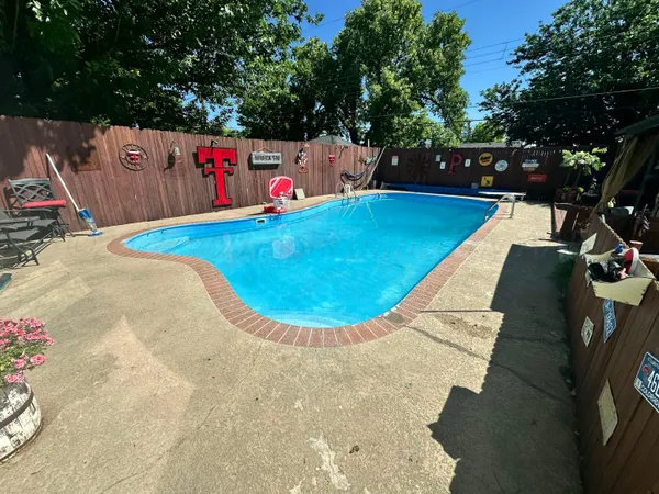 a view of yard with swimming pool and outdoor seating