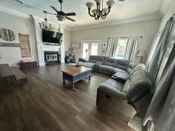 a living room with furniture a flat screen tv and a fireplace