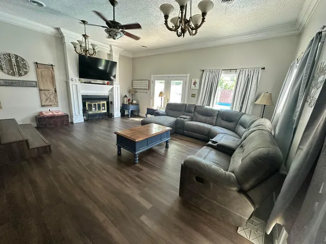a living room with furniture a flat screen tv and a fireplace