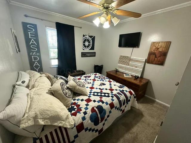 a bedroom with a bed and painting on the wall
