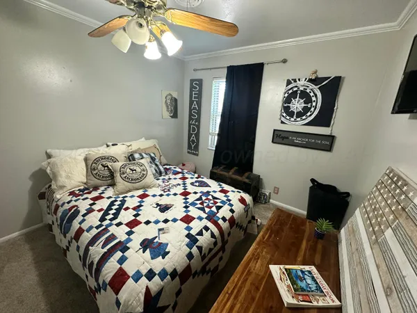 a bedroom with two beds and windows