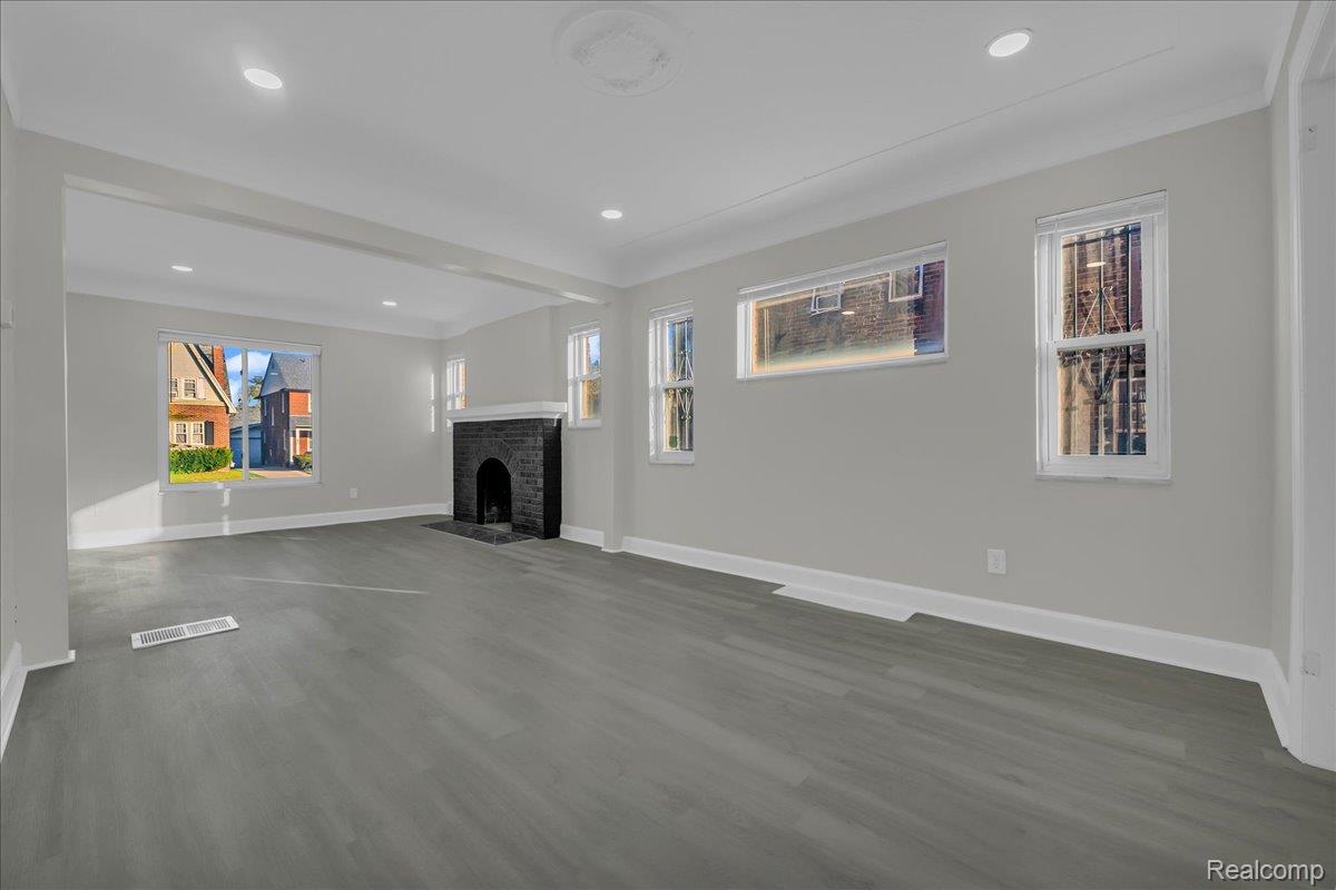 16717 Fielding Street Detroit, MI 48219 - Photo 11 of 46 Unfurnished living room featuring dark wood finished floors, recessed lighting, and a fireplace