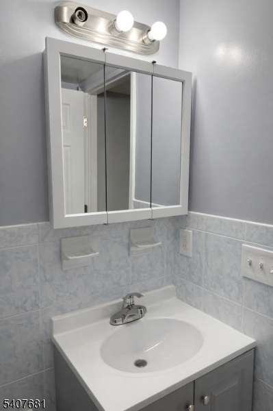 28 Branford Street Newark, NJ 07114 - Photo 1 of 15 a bathroom with a sink and a mirror