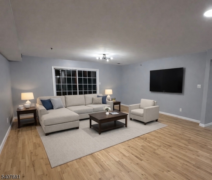 28 Branford Street Newark, NJ 07114 - Photo 11 of 15 a living room with furniture and a flat screen tv
