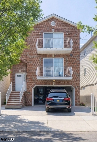 28 Branford Street Newark, NJ 07114 - Photo 13 of 15 a car parked in front of a house
