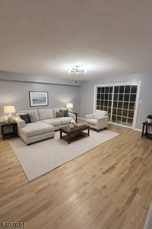 a living room with furniture a window and potted plant