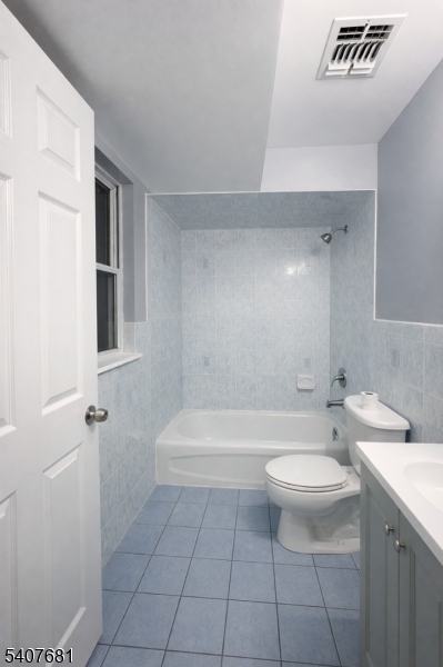 28 Branford Street Newark, NJ 07114 - Photo 4 of 15 a bathroom with a sink a toilet and shower