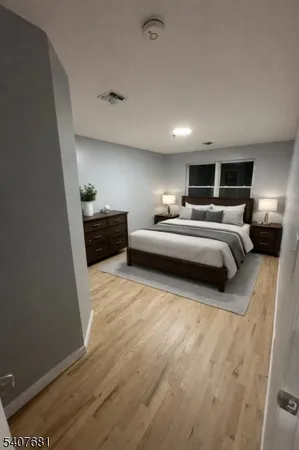 a large bedroom with a bed and furniture