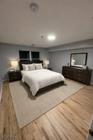 a bedroom with a large bed and a large mirror