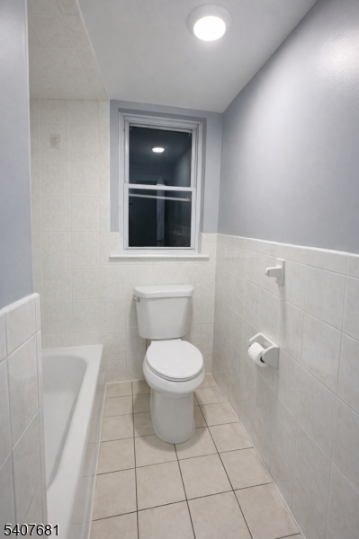 28 Branford Street Newark, NJ 07114 - Photo 7 of 15 a bathroom with a toilet and a shower