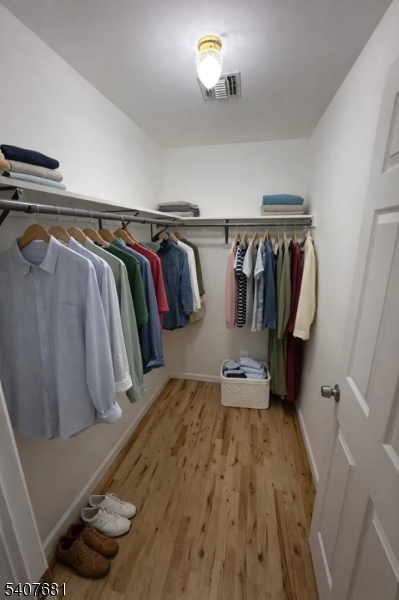 28 Branford Street Newark, NJ 07114 - Photo 9 of 15 a view of walk in closet with clothes and shoes