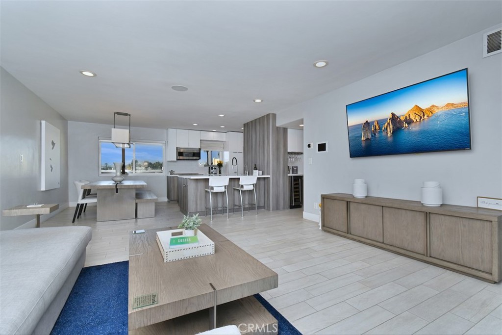 a living room with furniture and kitchen view