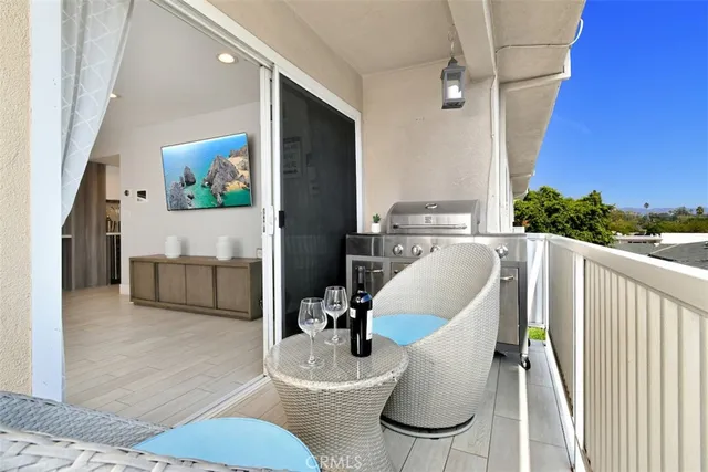 a living room with furniture and a view of kitchen