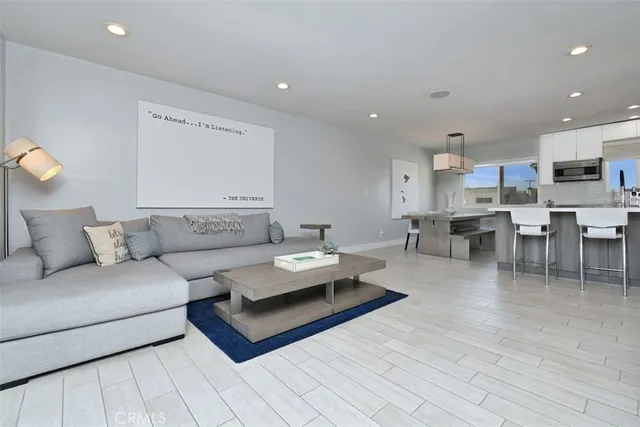 a living room with furniture and kitchen view