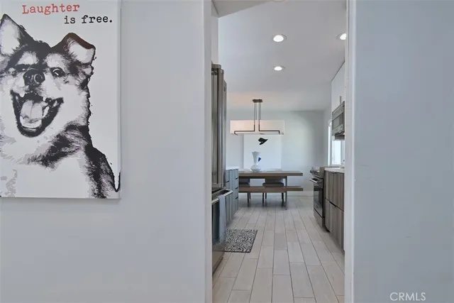 a kitchen with cabinets a sink and chairs