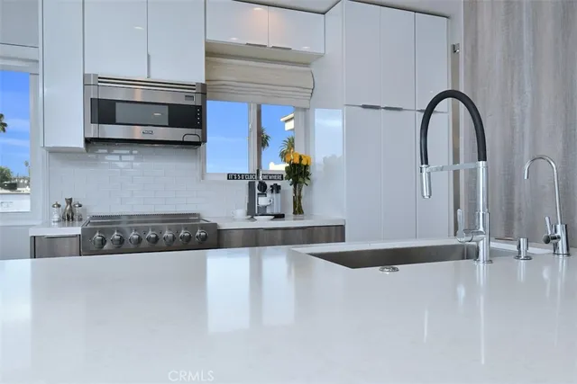 a kitchen with stainless steel appliances a stove a microwave and cabinets