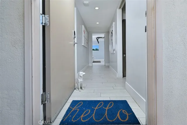 a view of hallway with wooden floor